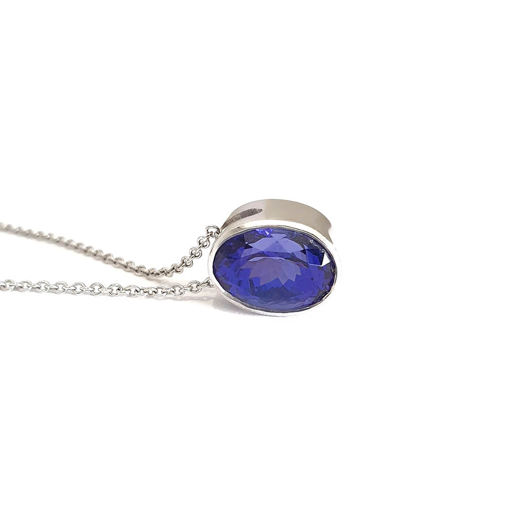 Luxuriously Suspended Slim Bezel Oval Tanzanite Pendant