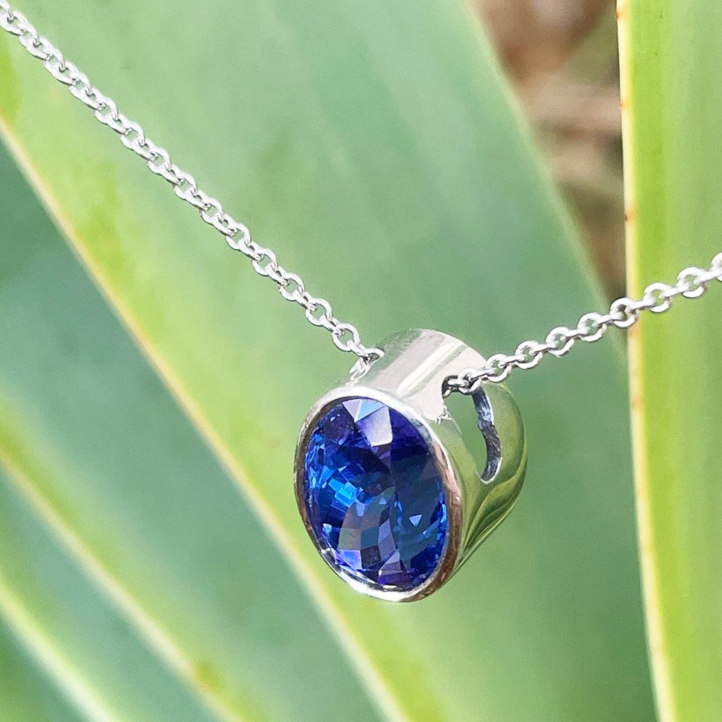Luxuriously Suspended Slim Bezel Oval Tanzanite Pendant