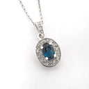 Oval London Blue Topaz And White Gold Diamond Halo Pendant