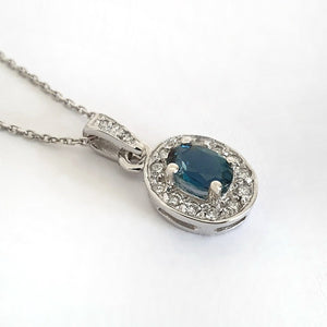 Oval London Blue Topaz And White Gold Diamond Halo Pendant