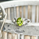 Oval Peridot With Twisted Shoulders And Diamond Highlight Ring