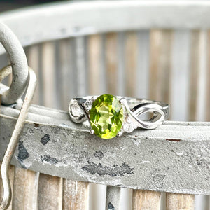 Oval Peridot With Twisted Shoulders And Diamond Highlight Ring