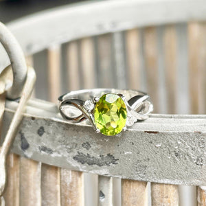 Oval Peridot With Twisted Shoulders And Diamond Highlight Ring
