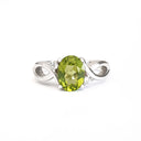 Oval Peridot With Twisted Shoulders And Diamond Highlight Ring