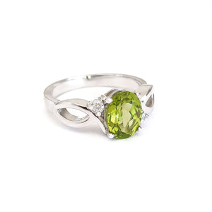 Oval Peridot With Twisted Shoulders And Diamond Highlight Ring
