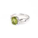 Oval Peridot With Twisted Shoulders And Diamond Highlight Ring