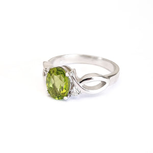 Oval Peridot With Twisted Shoulders And Diamond Highlight Ring