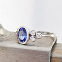 Oval Tube Set Tanzanite with Trilogy Diamond Shoulder White Gold Ring