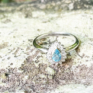 Radiant Pear Cut Blue Topaz with Diamond Halo Ring