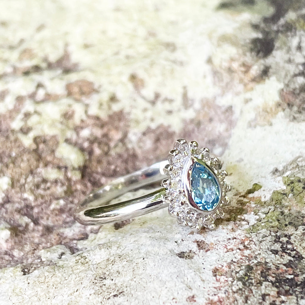 Radiant Pear Cut Blue Topaz with Diamond Halo Ring