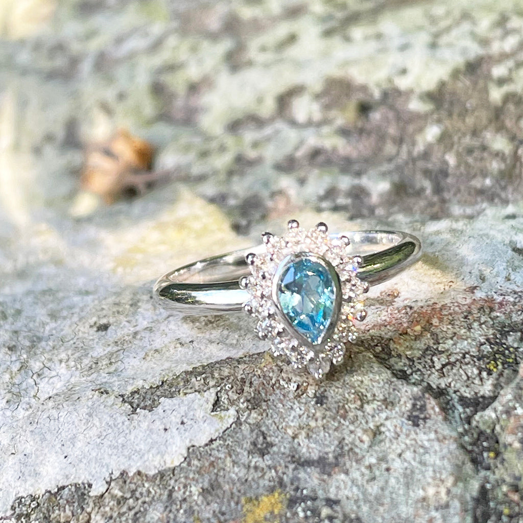 Radiant Pear Cut Blue Topaz with Diamond Halo Ring