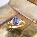 Regal Oval Tanzanite and Trilogy Diamond Shouldered Yellow Gold Ring