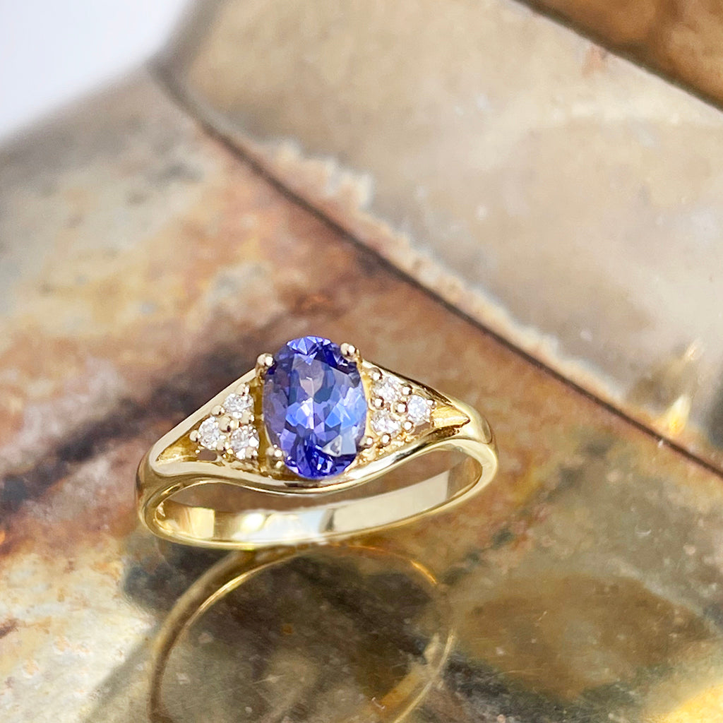 Regal Oval Tanzanite and Trilogy Diamond Shouldered Yellow Gold Ring