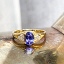 Regal Oval Tanzanite and Trilogy Diamond Shouldered Yellow Gold Ring