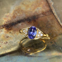Regal Oval Tanzanite and Trilogy Diamond Shouldered Yellow Gold Ring