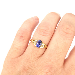 Regal Oval Tanzanite and Trilogy Diamond Shouldered Yellow Gold Ring