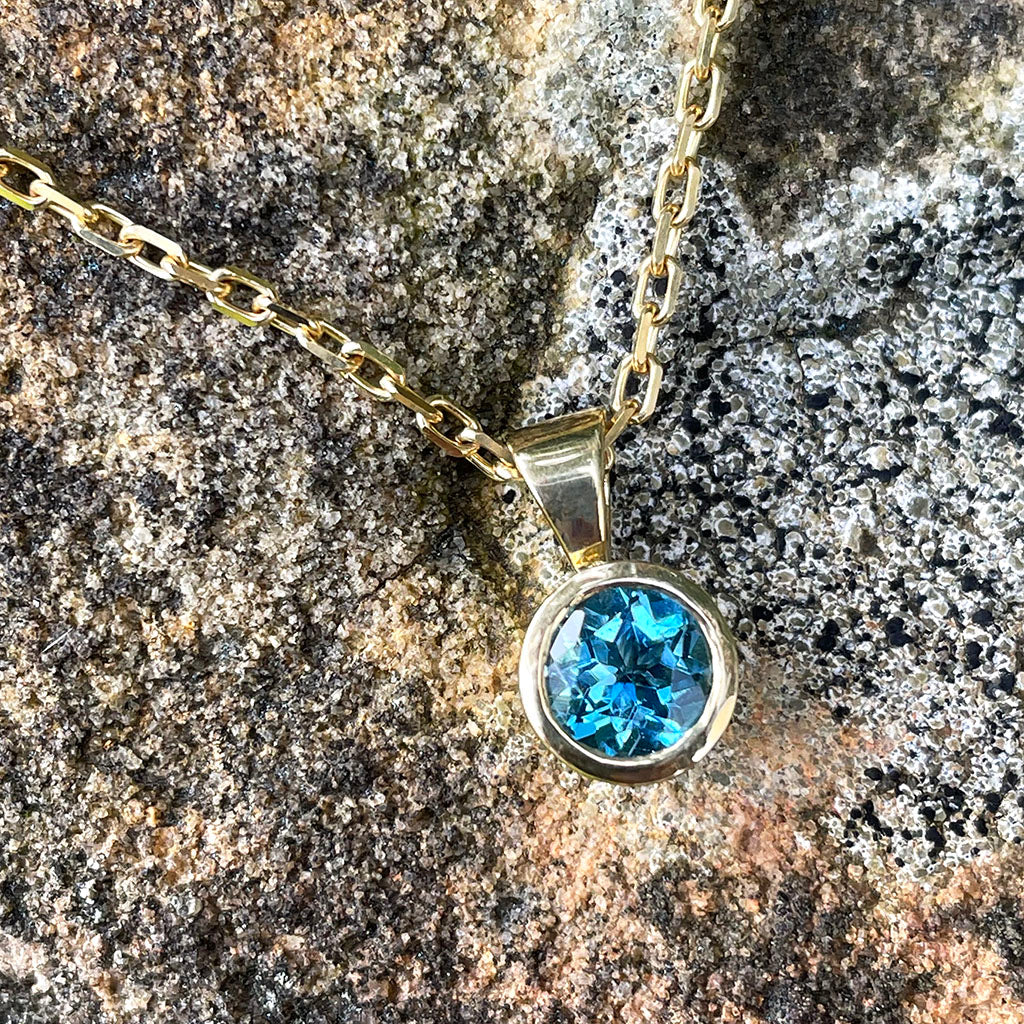 Round Bezel Set Blue Topaz with Fixed Bale Yellow Gold Pendant And Chain