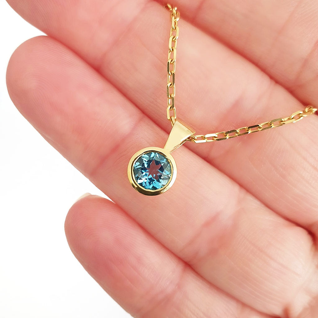 Round Bezel Set Blue Topaz with Fixed Bale Yellow Gold Pendant And Chain
