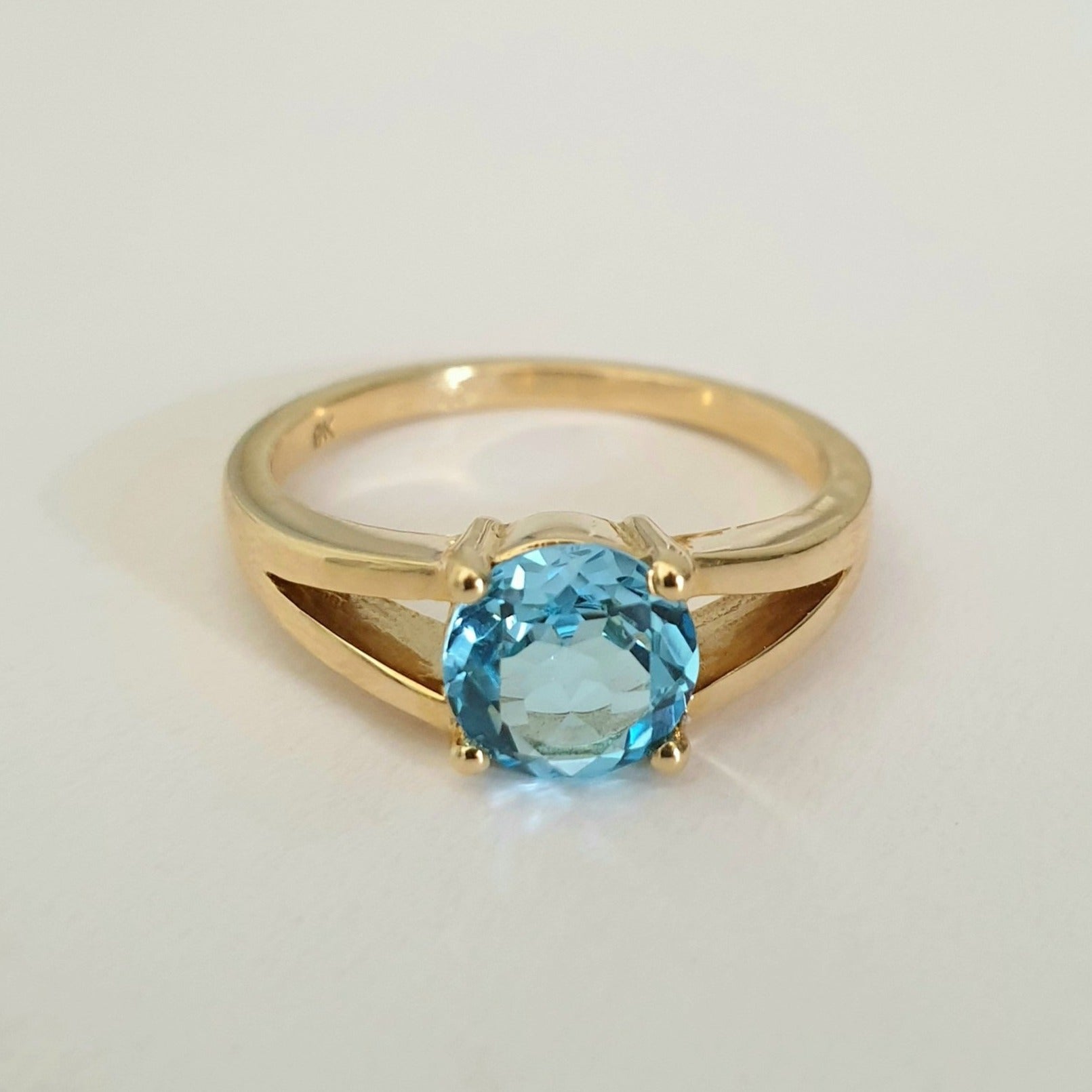 Solitaitre Round Cut and Claw Blue Topaz Yellow Gold Ring