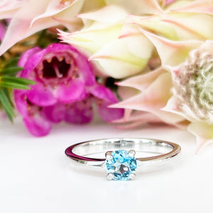 Silver Four Claw Solitaire Blue Topaz Round Cut Ring
