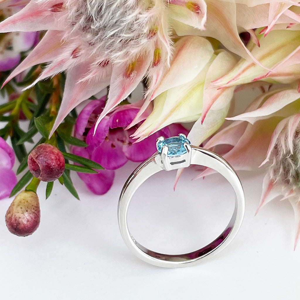 Silver Four Claw Solitaire Blue Topaz Round Cut Ring
