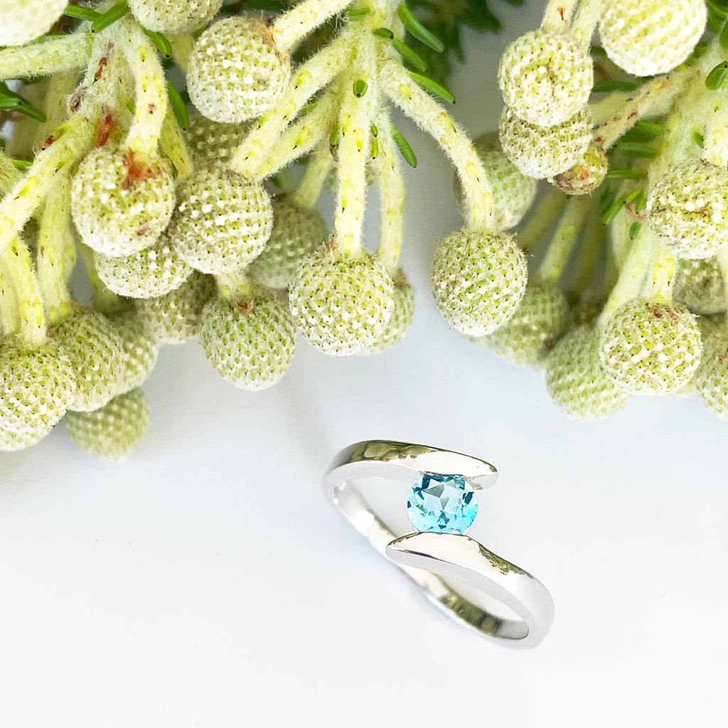 Silver Round Cut Blue Topaz Twist Ring