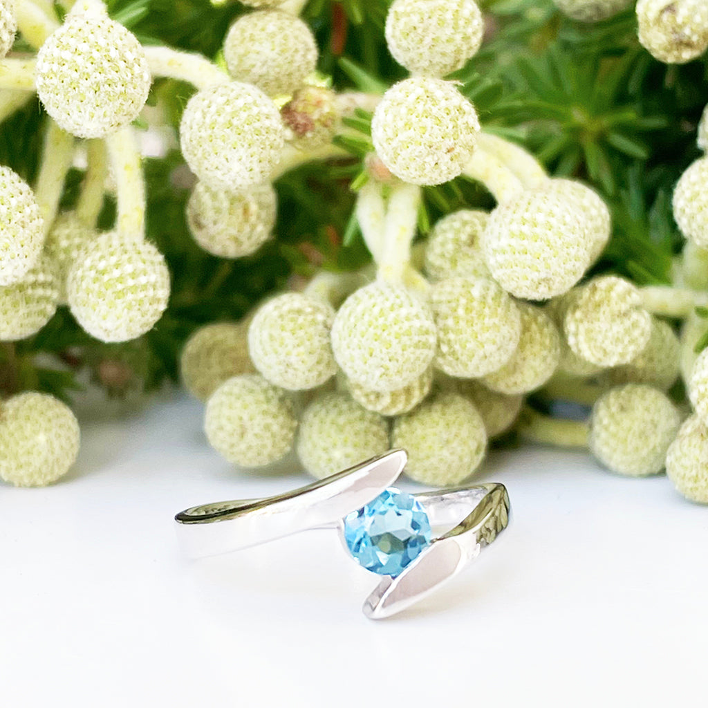 Silver Round Cut Blue Topaz Twist Ring