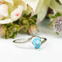 Silver Swish Pear Cut Blue Topaz Ring