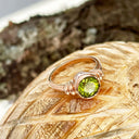 Three Stepped Shoulder Round Bezel Set Rose Gold Peridot Ring