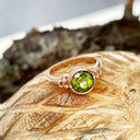 Three Stepped Shoulder Round Bezel Set Rose Gold Peridot Ring