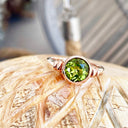 Three Stepped Shoulder Round Bezel Set Rose Gold Peridot Ring