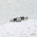 Trilogy Center White Diamond Ring with Black Diamond Accents