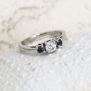 Trilogy Center White Diamond Ring with Black Diamond Accents