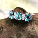 Triple Oval Cut Blue Topaz With Double Diamond Accents
