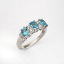 Triple Oval Cut Blue Topaz With Double Diamond Accents