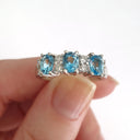 Triple Oval Cut Blue Topaz With Double Diamond Accents